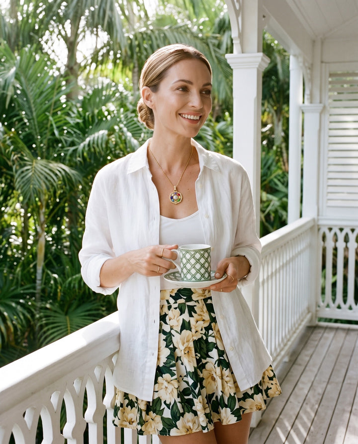 ORA Necklace worn on a veranda — coloured glass beads around the central pearl